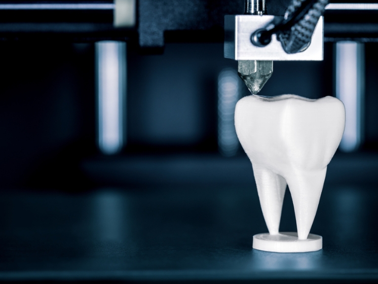 a stylised image of a tooth being 3D printed.