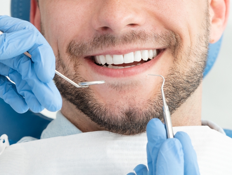 A smiling man receives cosmetic dentistry