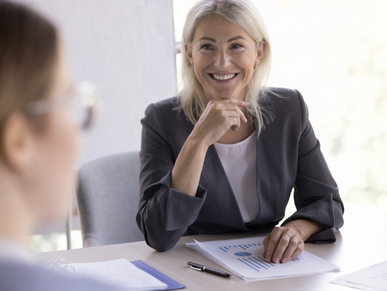 A smiling woman in a meeting